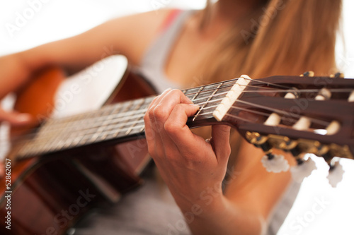 Photo: Closeup image of guitar in woman hands Closeup image of guitar in woman hands