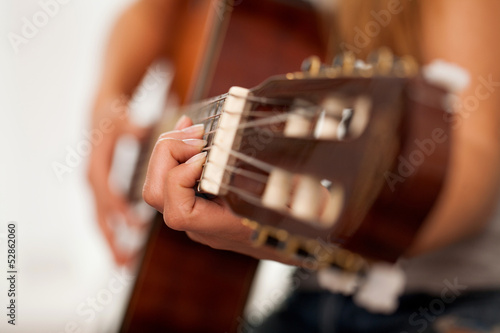 Photo: Closeup image of guitar in woman hands Closeup image of guitar in woman hands