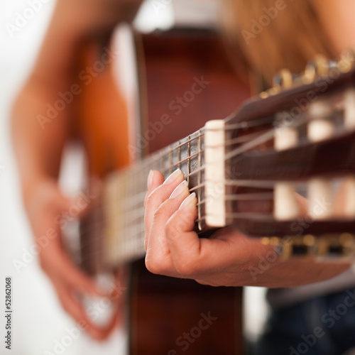 Photo: Closeup image of guitar in woman hands Closeup image of guitar in woman hands