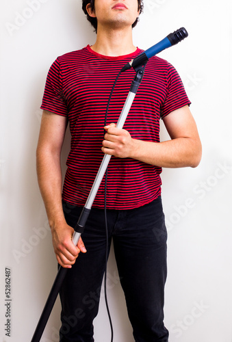 Photo: Young sound man with boom Young sound man with boom