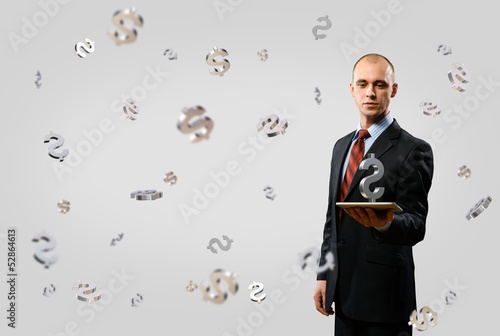 Photo: man holding tablet with dollar symbol man holding tablet with dollar symbol