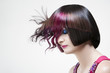 Photo: Woman with striking makeup and extravagant hairstyle in studio. Woman with striking makeup and extravagant hairstyle in studio.
