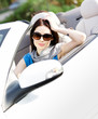 Portrait of dreamy woman wearing sunglasses in the car