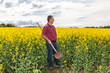 Farmer in inspection of his rapeseed field