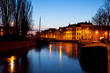 ship and boats on frozen canal at night