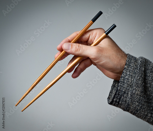 Photo: Male hand with chopsticks Male hand with chopsticks