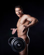 Portrait of astonished naked athlete with barbell