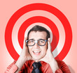 Business man in fear on target background