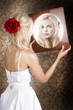 Dreamy woman looking at mirror reflection