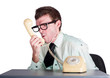 Angry businessman yelling down phone