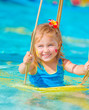 Happy girl on water swing