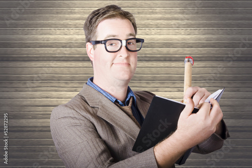 Photo: Nerd Businessman minuting massive business plan Nerd Businessman minuting massive business plan