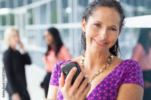 Photo: Hispanic woman holding cell phone Hispanic woman holding cell phone