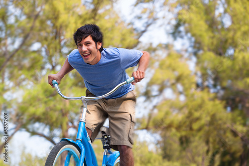 Photo: Young Man on bike wth trees Young Man on bike wth trees