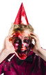 Foto: Woman with horror make up and party hat Woman with horror make up and party hat