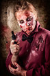 Foto: Evil demented zombie holding hand gun. Robbery Evil demented zombie holding hand gun. Robbery