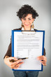 Young Businesswoman Showing a Contract to Sign
