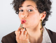 Young Businesswoman Applying Lipstick