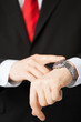 man looking at wristwatch