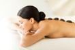 woman in spa with hot stones