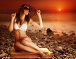 Sexy model on the beach on sunset