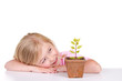 child with plant smiling