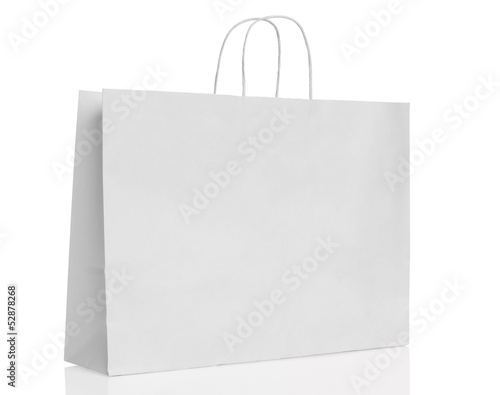 Photo: White paper shopping bag isolated. White paper shopping bag isolated.