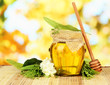 Photo: Jar of honey with flowers of lime, acacia Jar of honey with flowers of lime, acacia