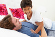 Father And Son Lying In Bed Together