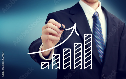 Photo: Businessman drawing a rising arrow Businessman drawing a rising arrow