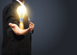 Holding light bulb power of thinking creative idea