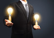 Holding light bulb power of thinking creative idea