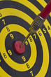 the dart hitting the middle of dartboard, close up