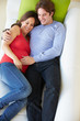 Photo: Overhead View Of Man Relaxing On Sofa With Pregnant Wife Overhead View Of Man Relaxing On Sofa With Pregnant Wife