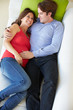 Photo: Overhead View Of Man Relaxing On Sofa With Pregnant Wife Overhead View Of Man Relaxing On Sofa With Pregnant Wife