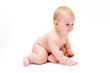 Baby crawling with a pacifier in his hands