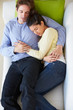 Overhead View Of Couple Relaxing On Sofa
