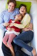 Overhead View Of Family Relaxing On Sofa