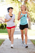 Photo: Two Female Runners Exercising On Suburban Street Two Female Runners Exercising On Suburban Street