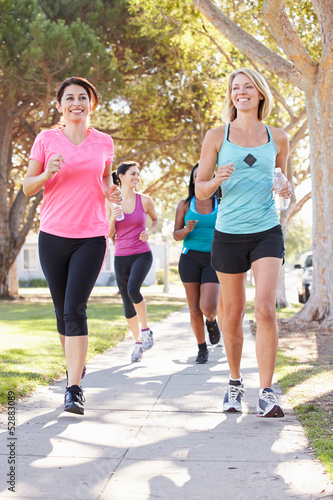 Photo: Group Of Female Runners Exercising On Suburban Street Group Of Female Runners Exercising On Suburban Street