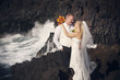 Happy bride and groom, waterfall in the background.