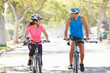 Couple Cycling On Suburban Street