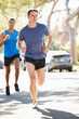 Photo: Male Runners Exercising On Suburban Street Male Runners Exercising On Suburban Street