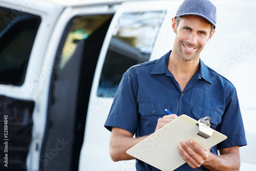 Photo: Portrait Of Delivery Driver With Clipboard Portrait Of Delivery Driver With Clipboard