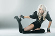 Young blonde in attractive high fashion black clothes
