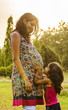 Mother and Daughter awaiting the upcoming happiness.