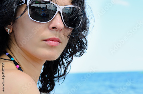 Photo: Portrait of a brunette on the beach Portrait of a brunette on the beach