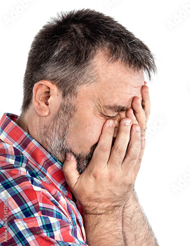 Photo: Middle age man suffering from a headache Middle age man suffering from a headache