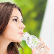 Young woman with water, outdoors