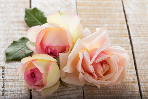 Photo: Fresh roses on wooden background Fresh roses on wooden background